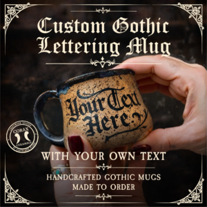Hand holding a custom gothic lettering mug with text 'Your Text Here' against a dark background.