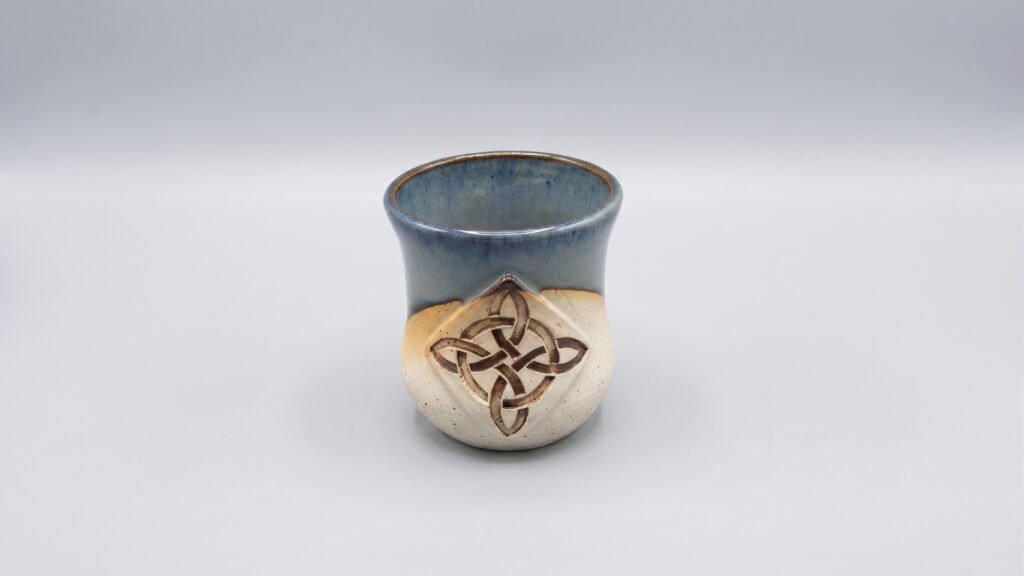 ceramic glazed cup with stamp design on the stoneware clay